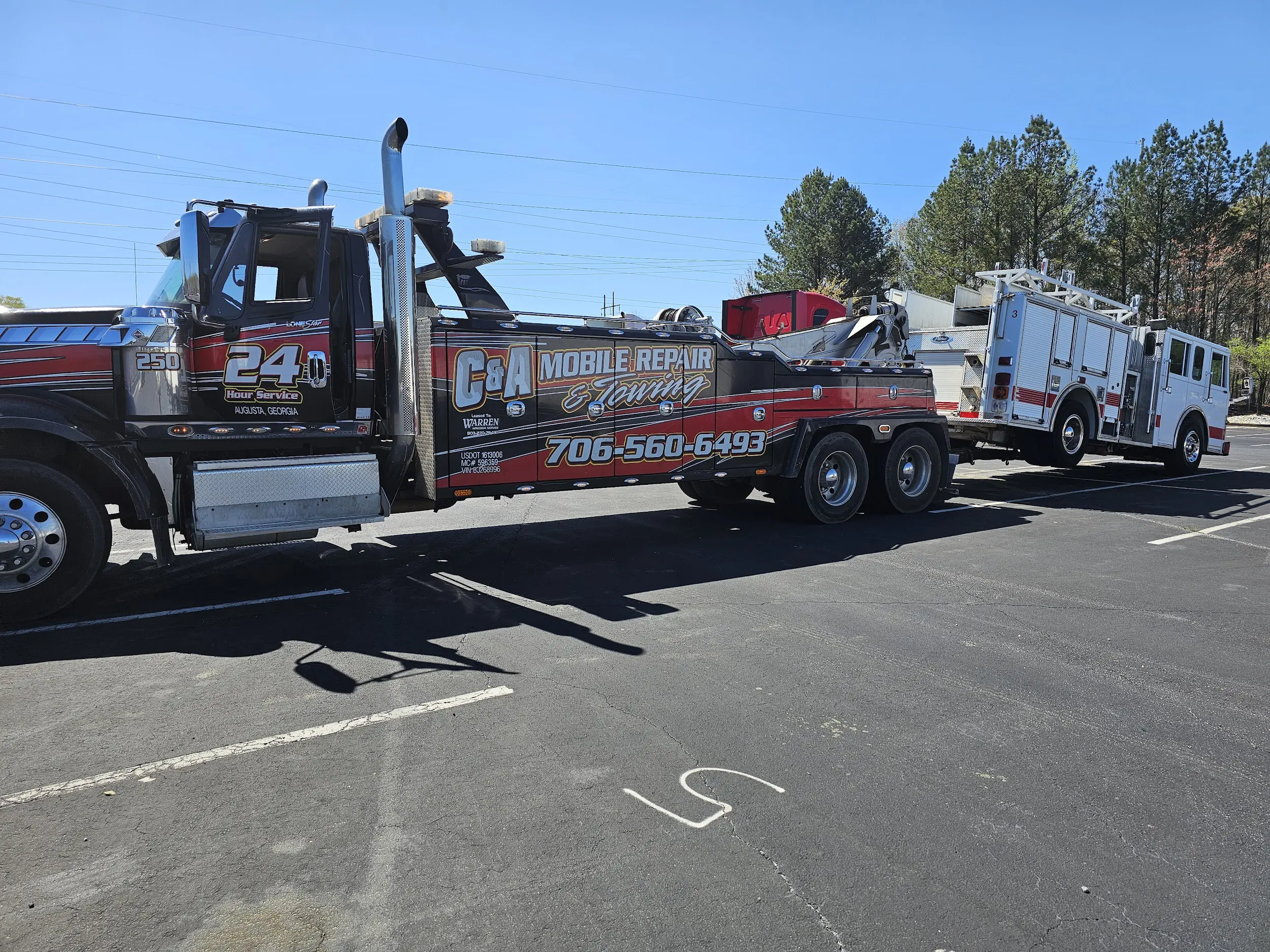 Tow truck hauling fire truck