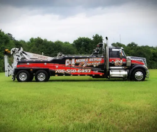 Tow truck in grassy field