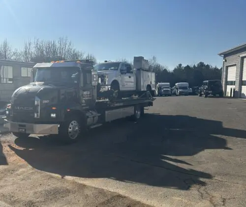 Tow truck carrying repair truck